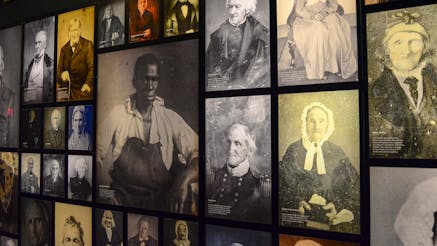 A photo of the Museum's wall of photographs of the Revolutionary generation who survived the Revolutionary War and lived into the age of photography.