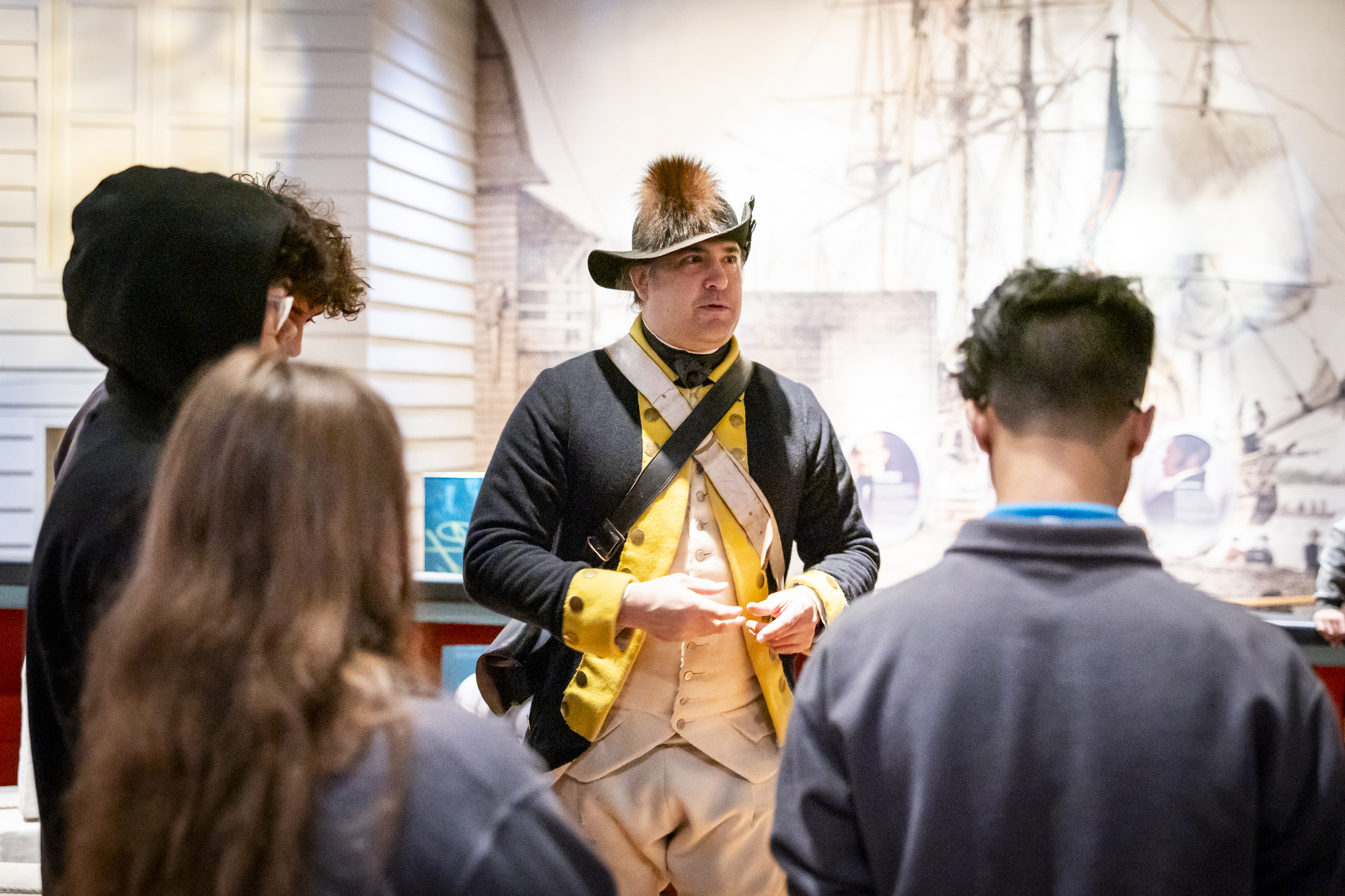 Museum educator dressed in 18th century jacket and hat