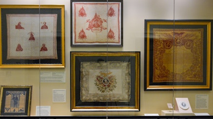 A display of five historic handkerchiefs in the Museum's second-floor atrium display case.