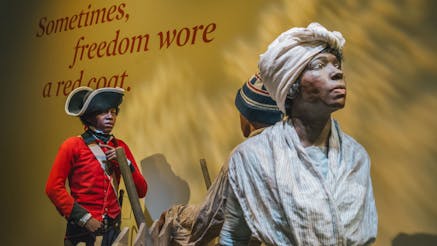 Finding Freedom tableau scene at the Museum depicting a British soldier of African descent trying to recruit a young boy of African descent to find freedom with the British army.