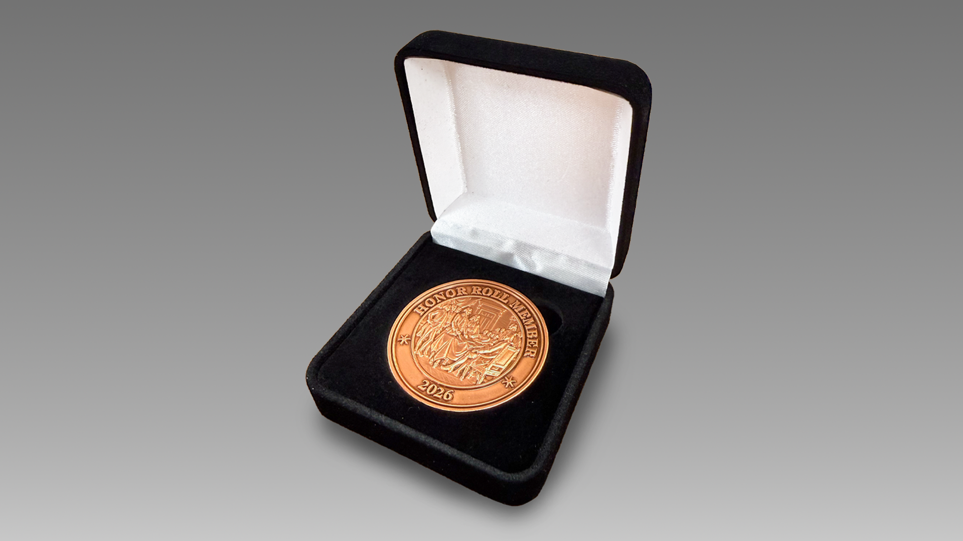 A large copper-colored coin in a black display box