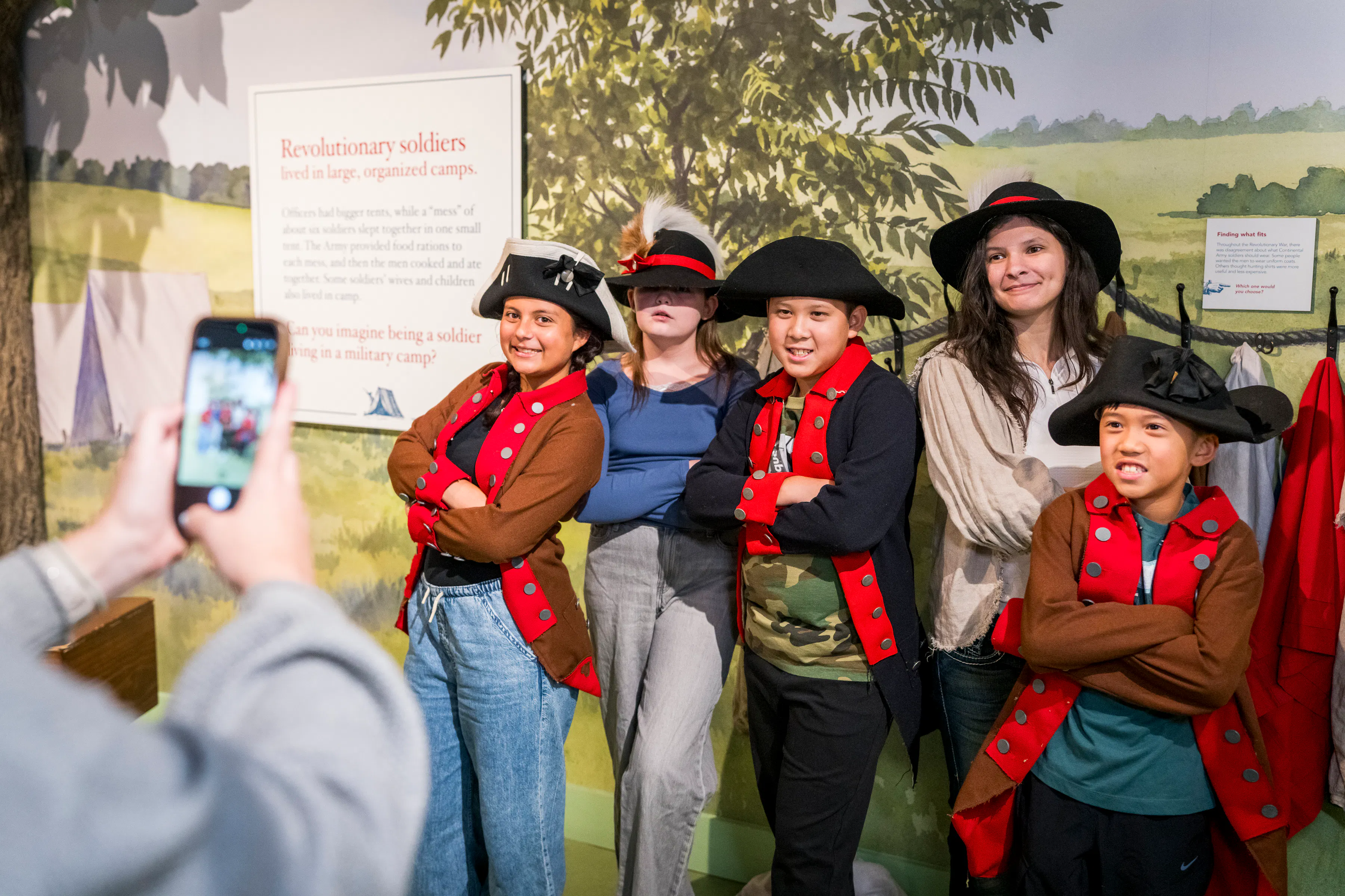 Parent taking a picture of four kids and one young woman