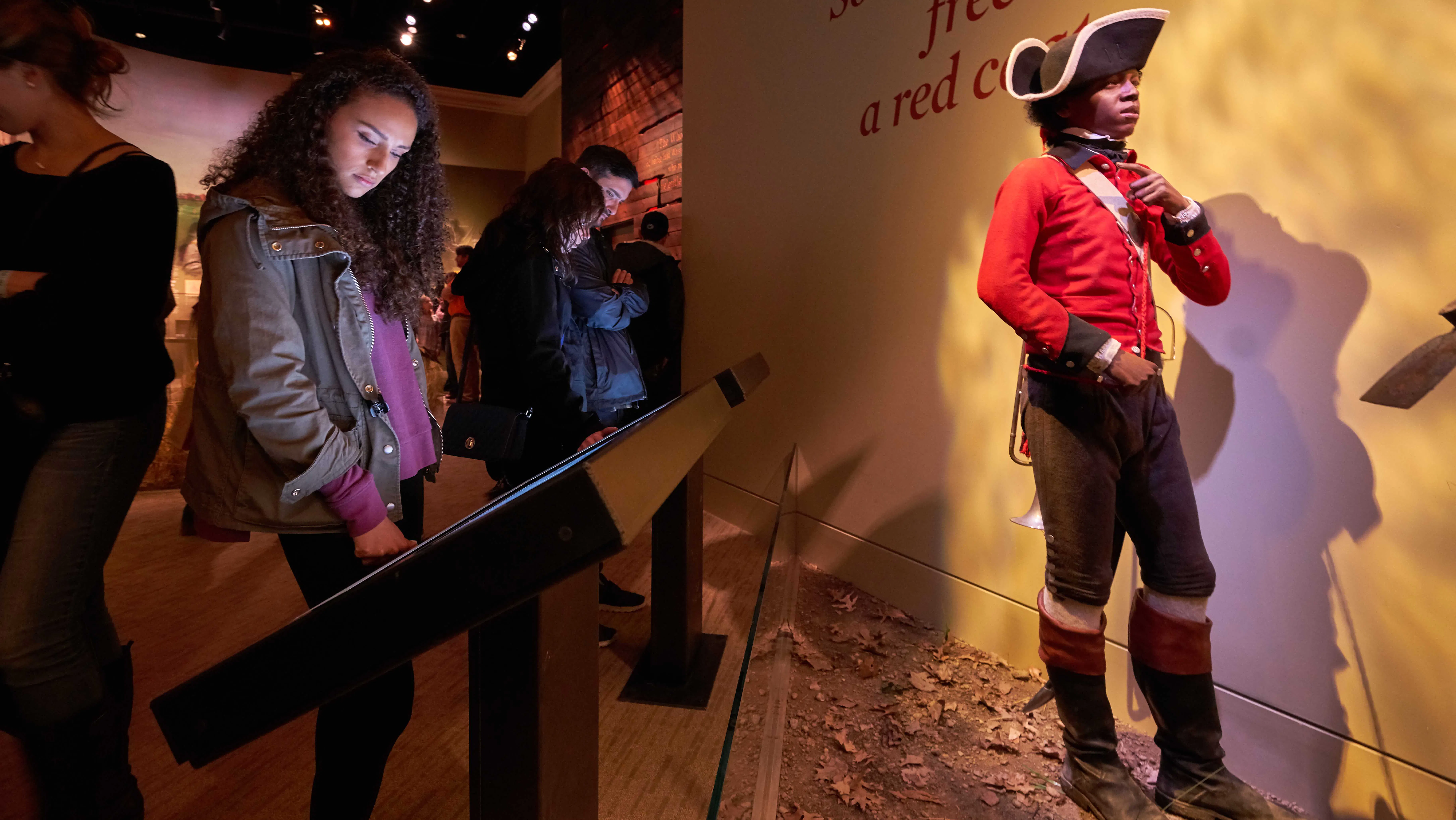 Guests interact with the Finding Freedom interactive in the galleries.