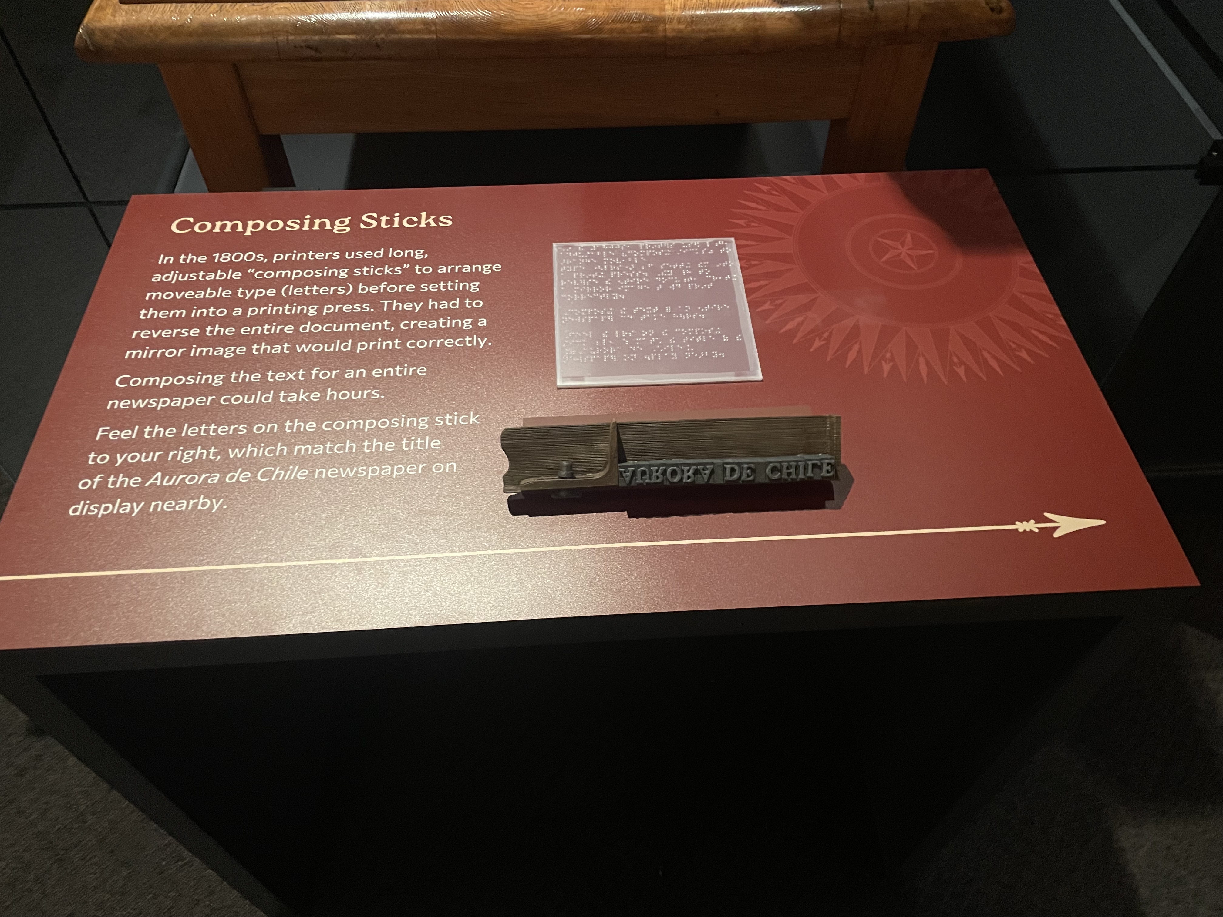 A panel with text and a raised stick with letters
