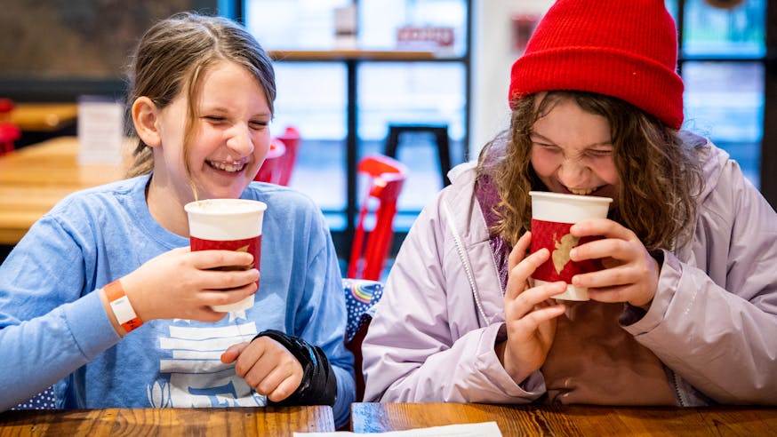 Two young visitors sip hot chocolate in the Museum's Cross Keys Cafe.