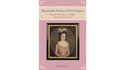 This image depicts the book cover of New England’s Remarkable Women by Carole Owens. The cover is pink with white borders on the top and bottom corners. In the center, there is a black framed portrait of a New England woman. She has brown hair with white feathers and is wearing a pink dress.