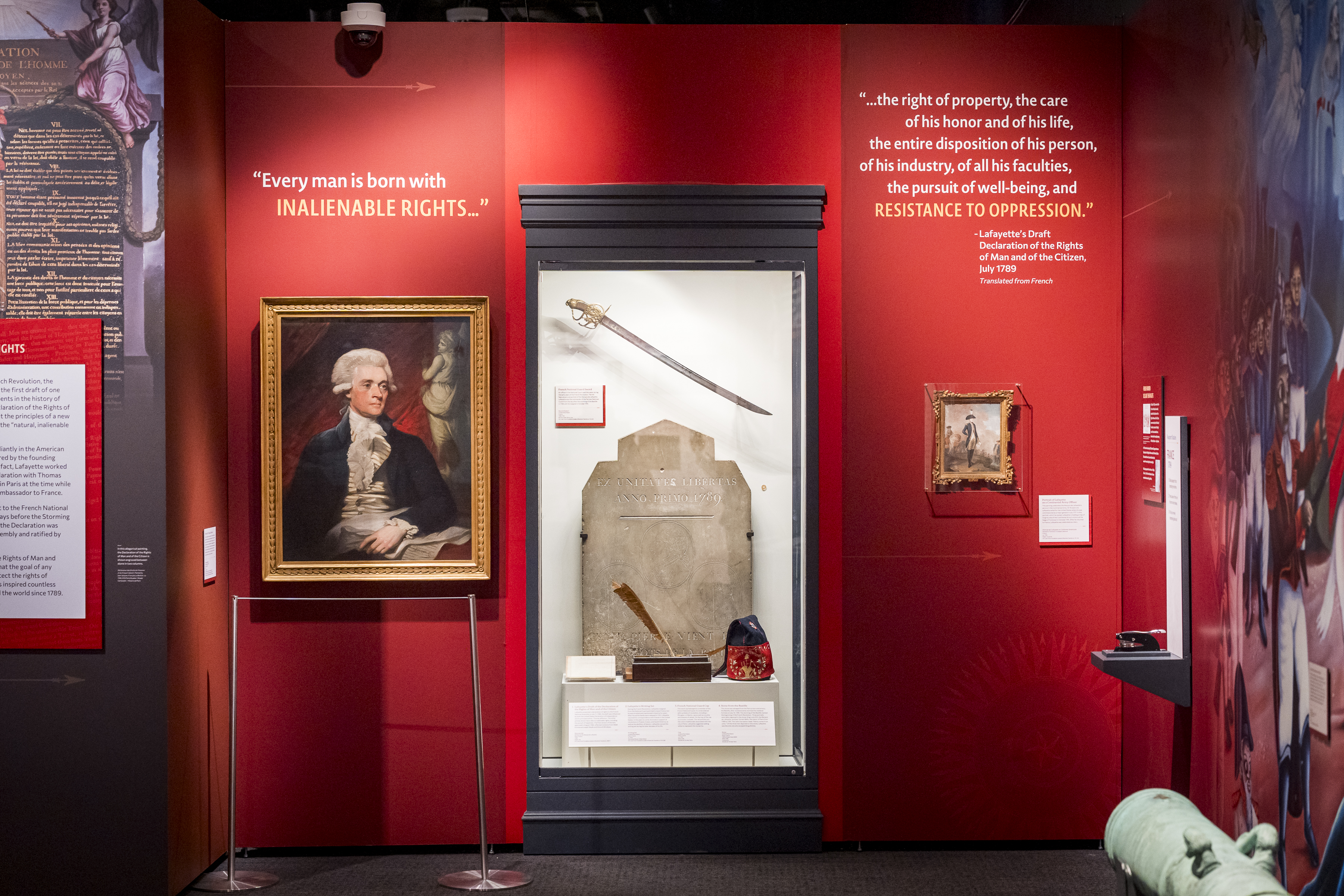 Portrait of Thomas Jefferson next to display case with Bastille