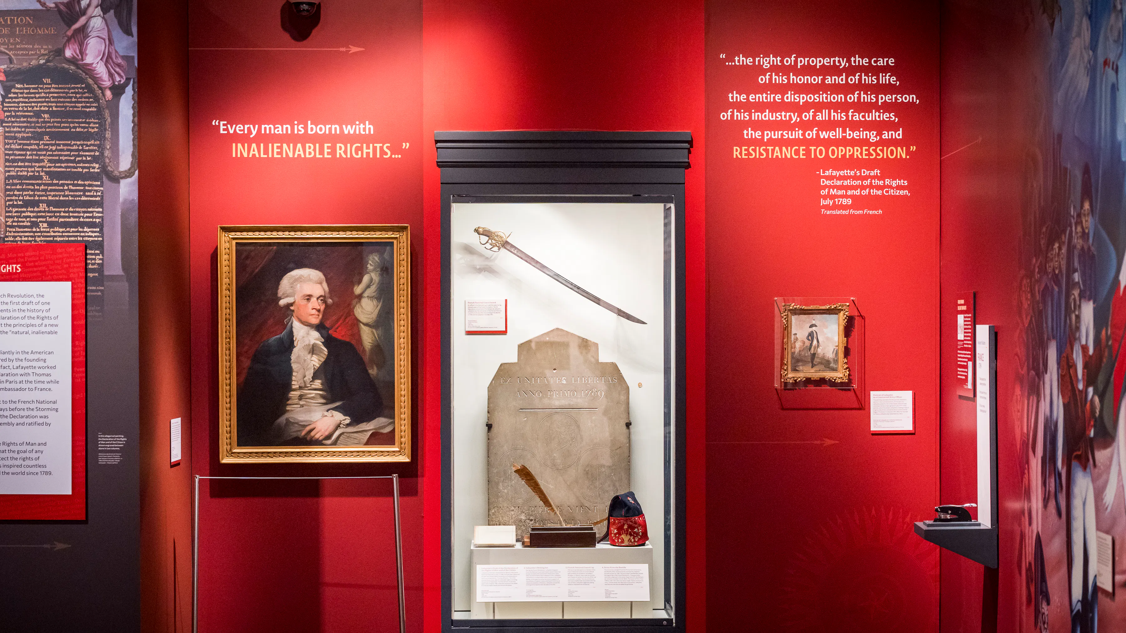 Portrait of Thomas Jefferson next to display case with Bastille