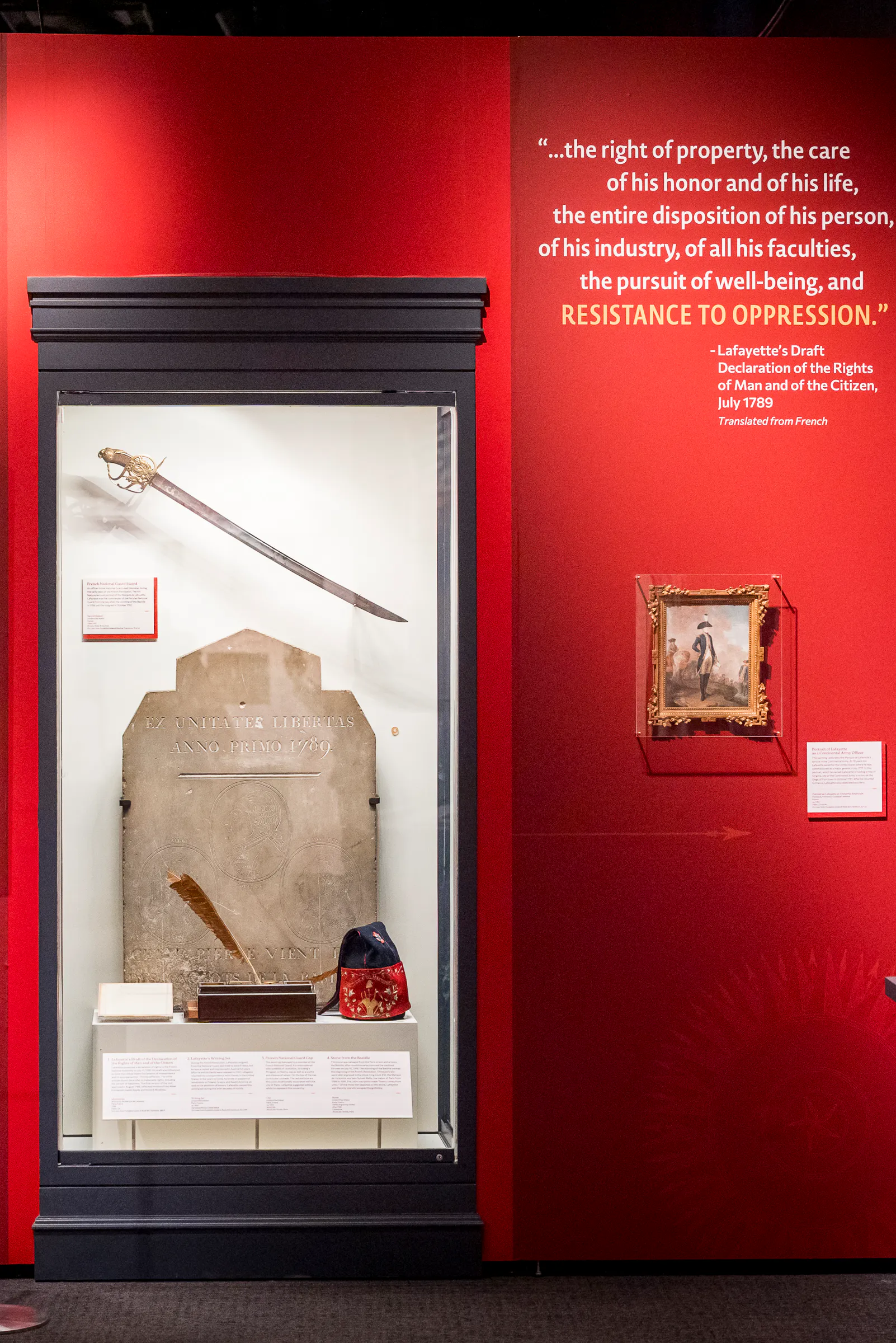 Portrait of Thomas Jefferson next to display case with Bastille