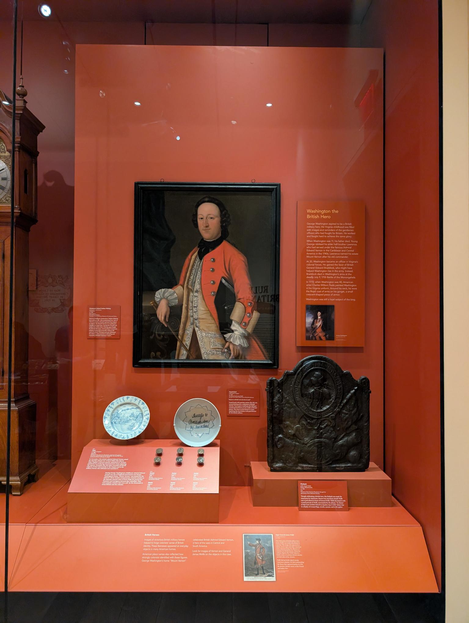 A Museum display case featuring a portrait of a man wearing a military uniform