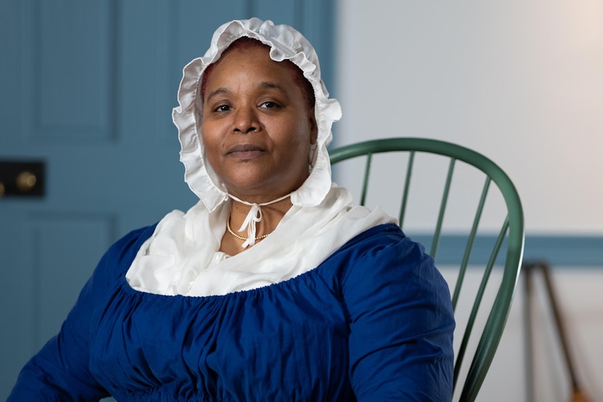Meet Elizabeth Freeman actress Katrina Hall in a blue dress with a white bonnet