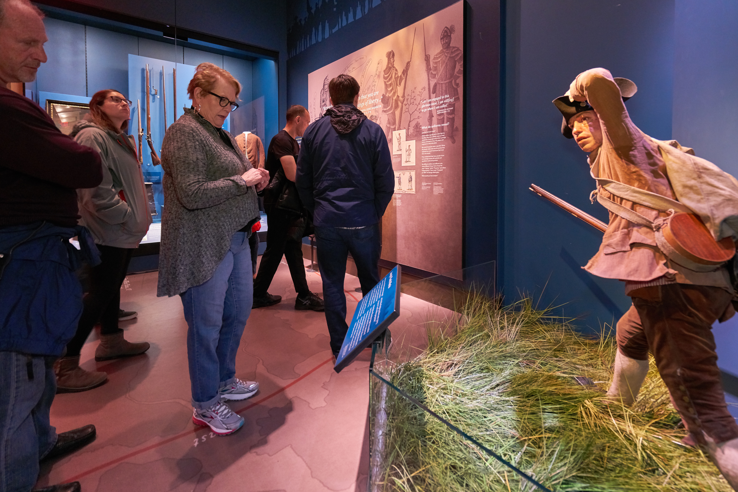 People looking at a tableau of a soldier in the Museum