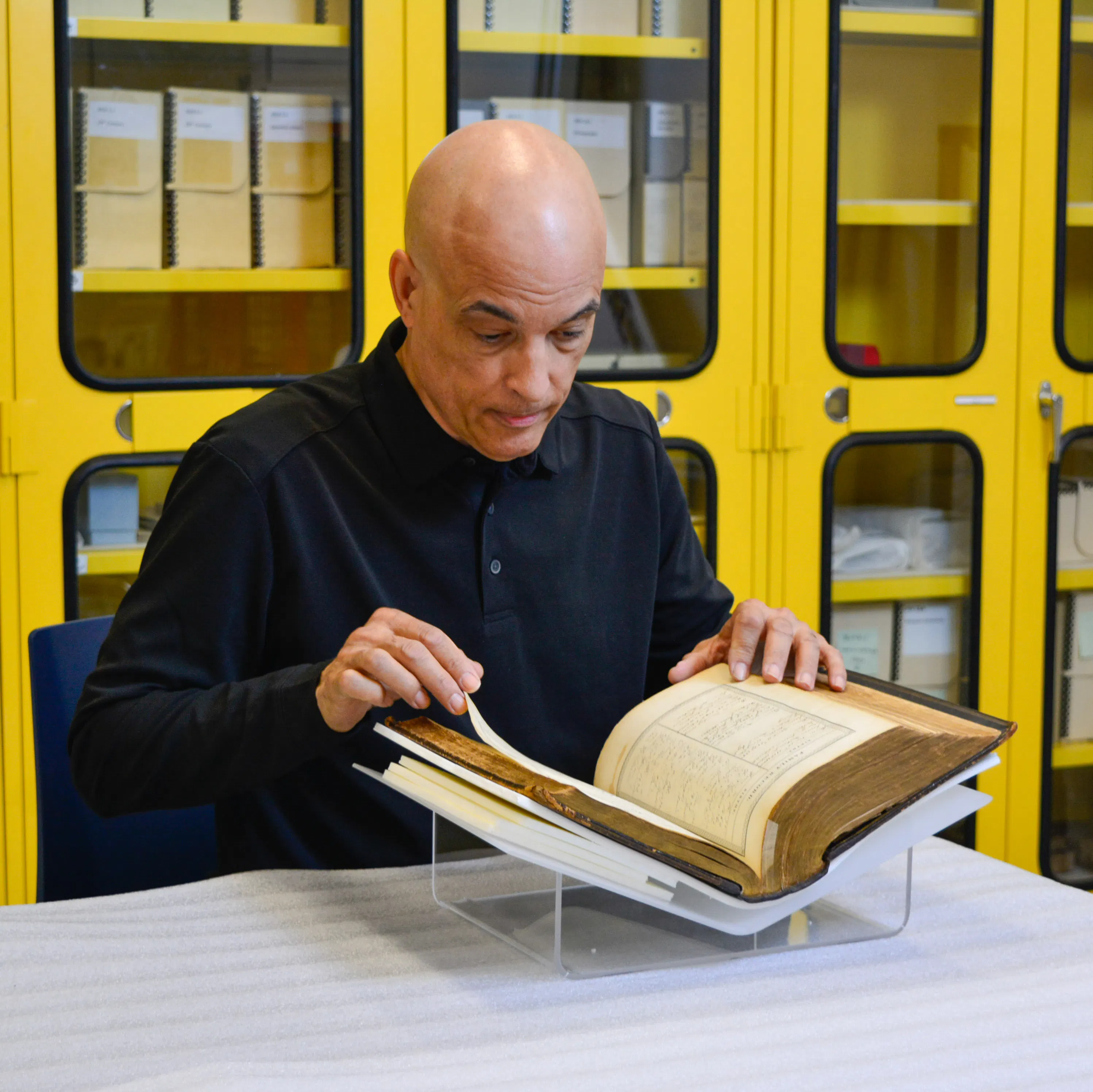 James Forten descendent Kip Forten Jacobs looks at the Forten family Bible, passed down for generations, in the Museum's collections workroom.