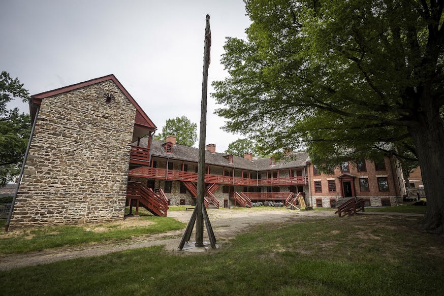 This image shows the stone structure of the Old Barracks Museum with red railings and details.