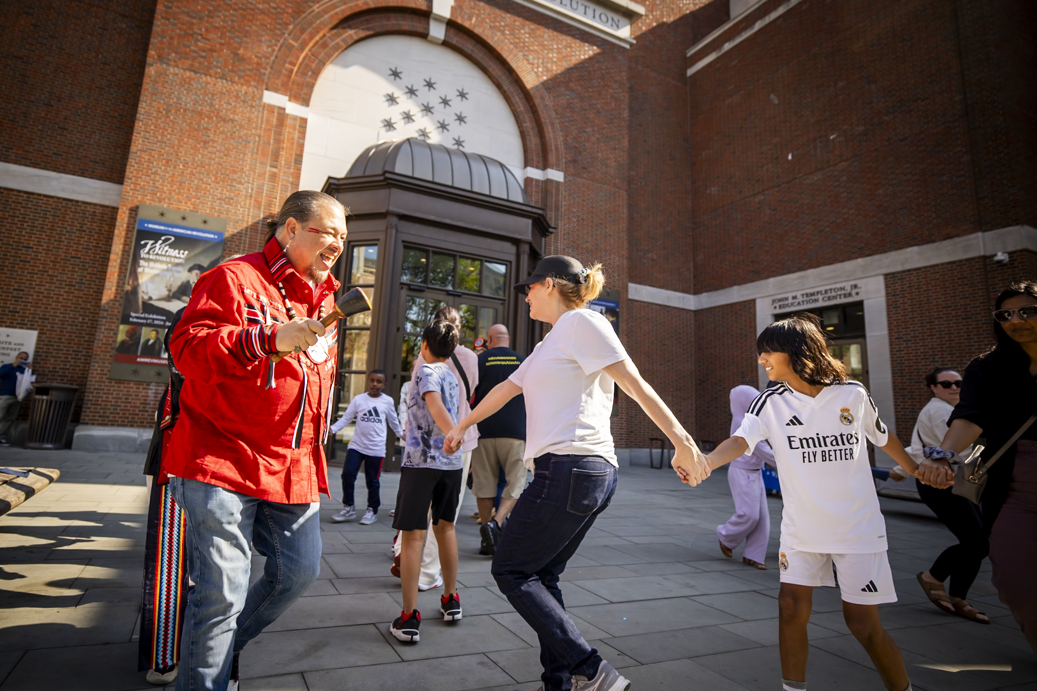 Man, women, and children dancing