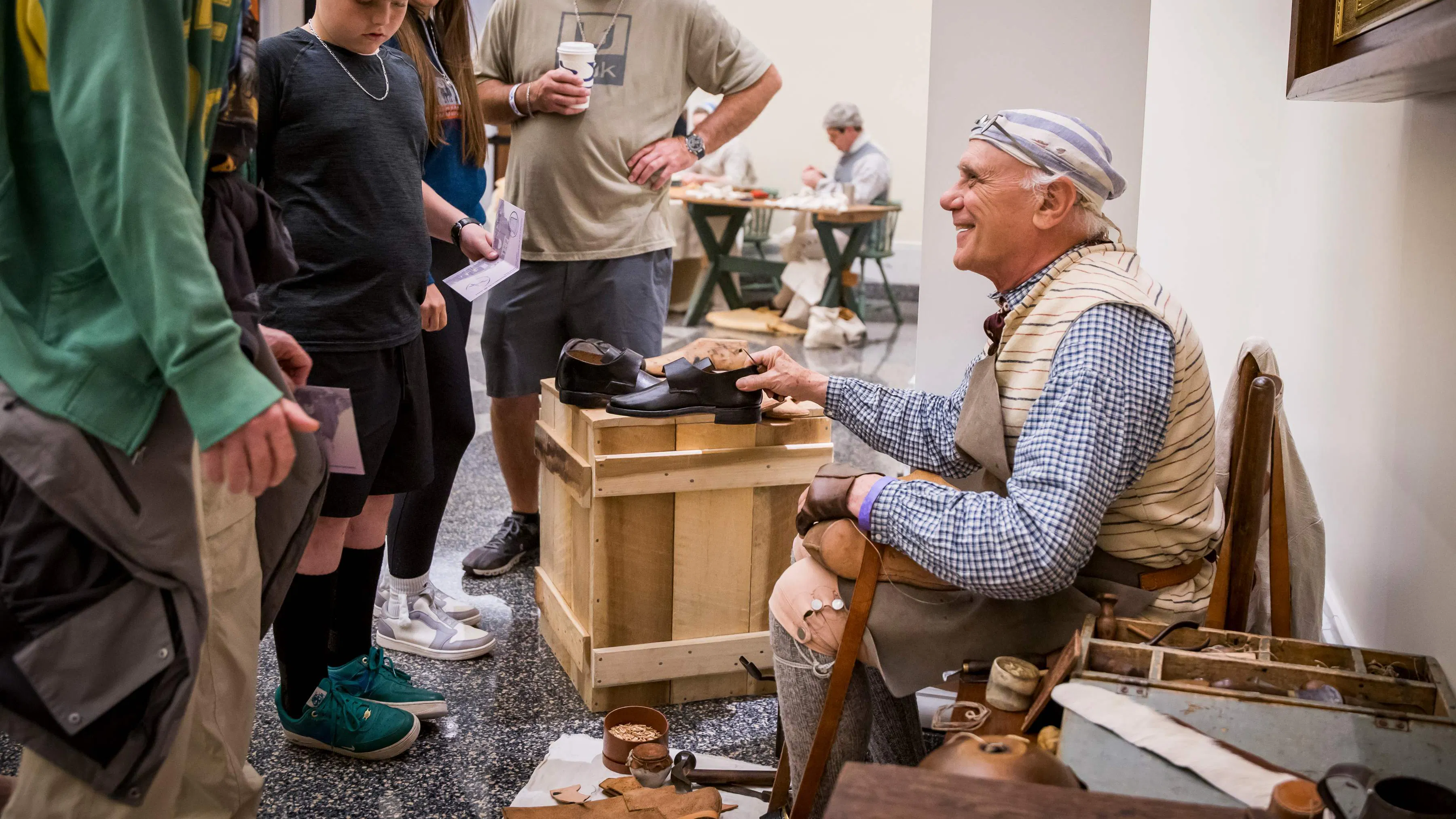 A costumed interpreter talks with guests