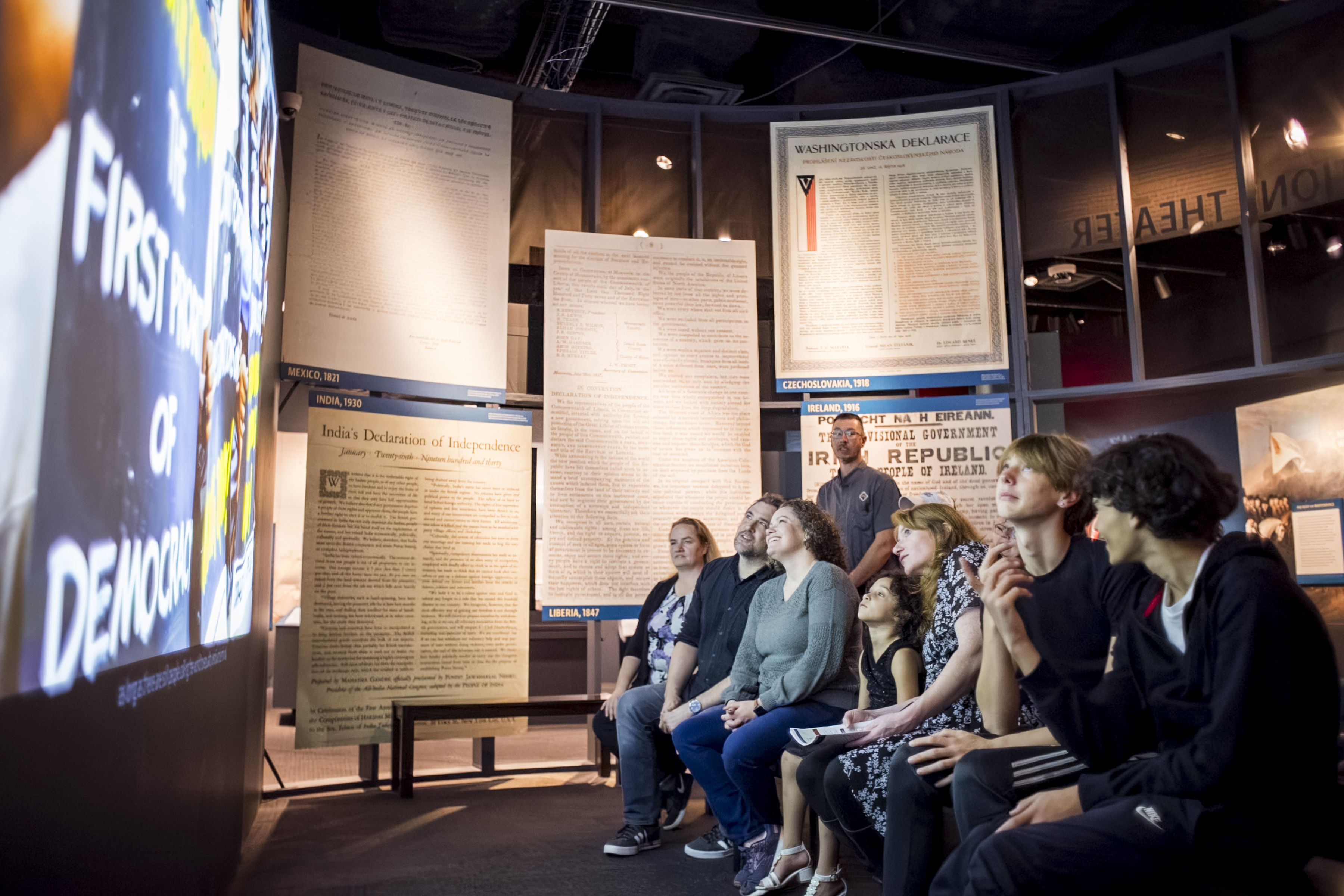 A group of people in Declarations Theater in the exhibition "The Declaration's Journey"