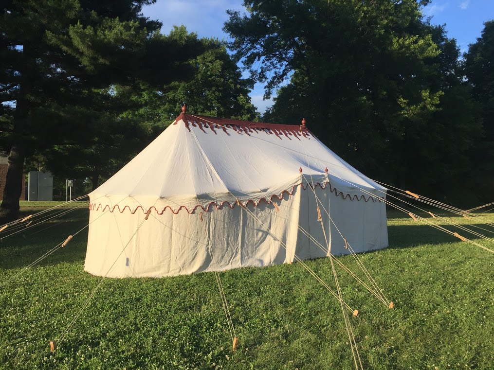This image shows the handsewn replica linen tent with a silk replica commander in chief standard out front at Morristown National Historical Park.