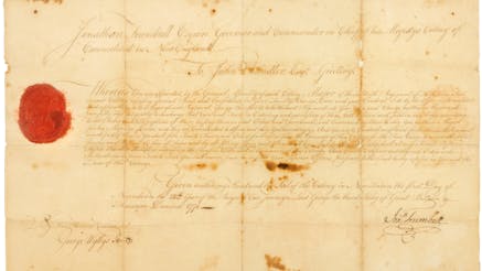 Stained and creased handwritten document marked with a red wax seal on the left side