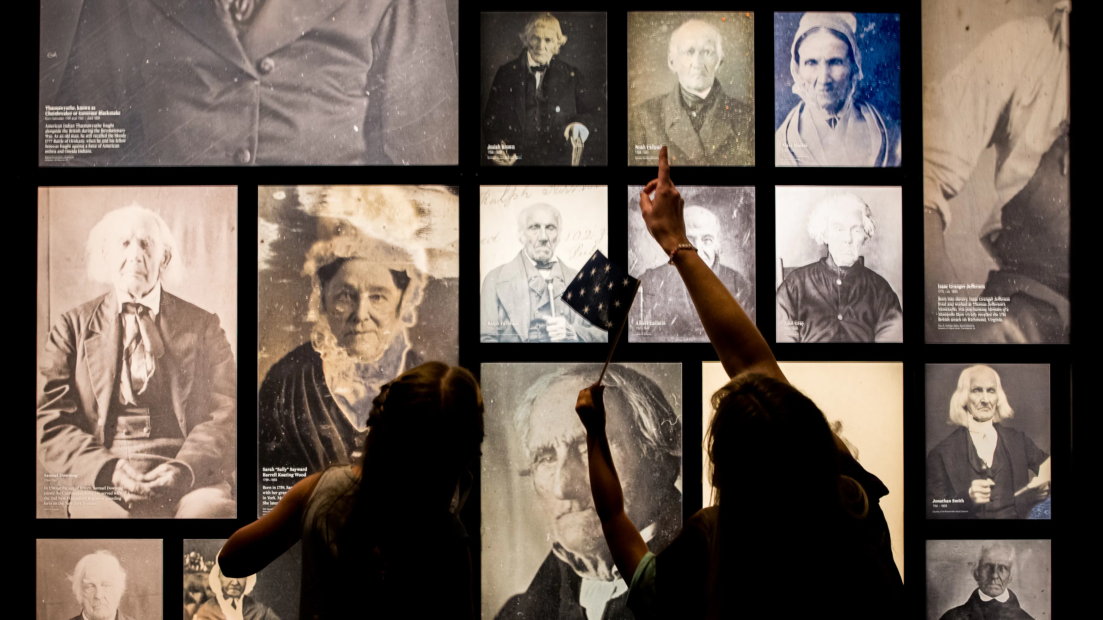 Guests with masks enjoy the images of Revolutionary War veterans.