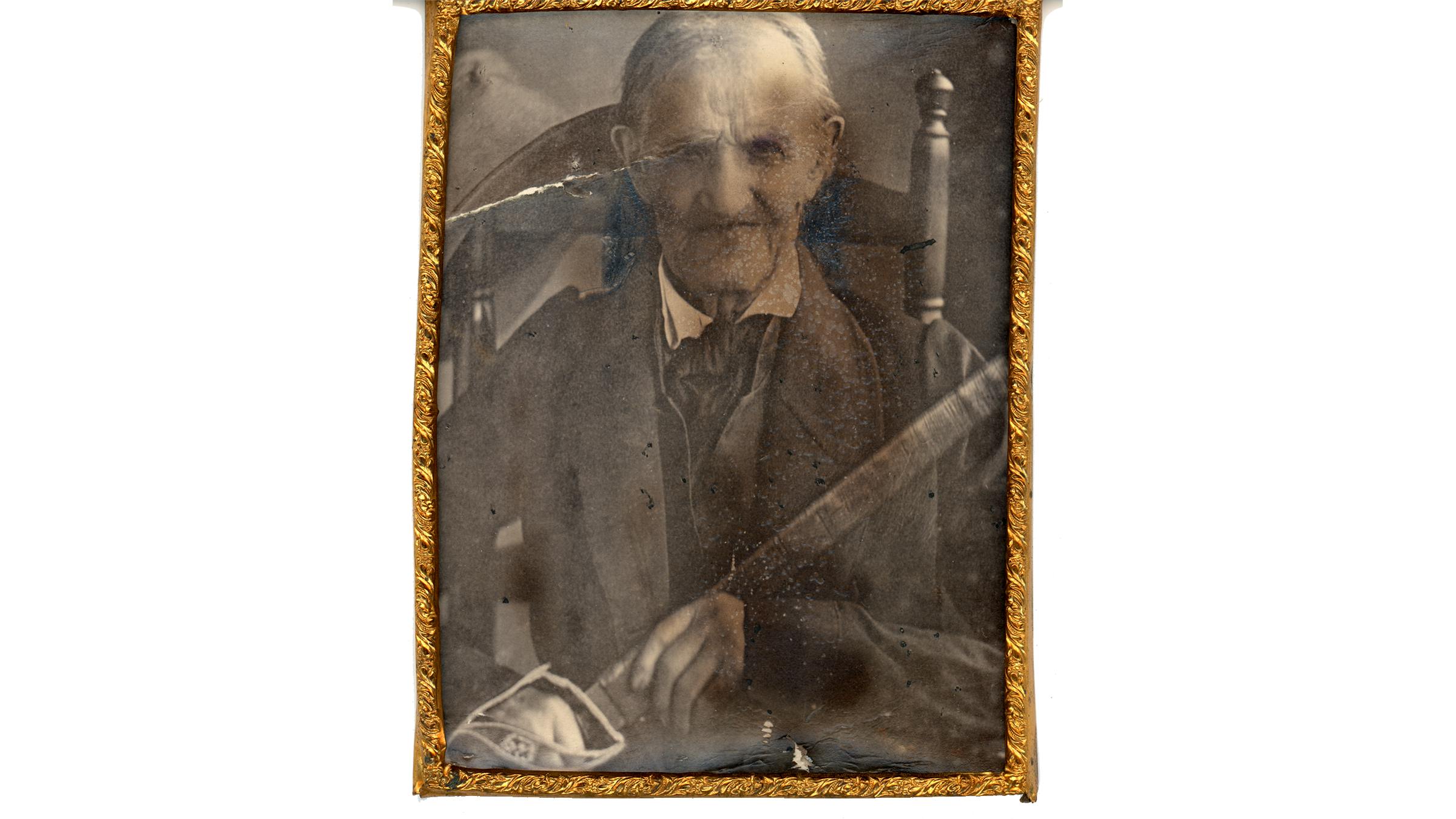 An old photo of a man posing with a sword