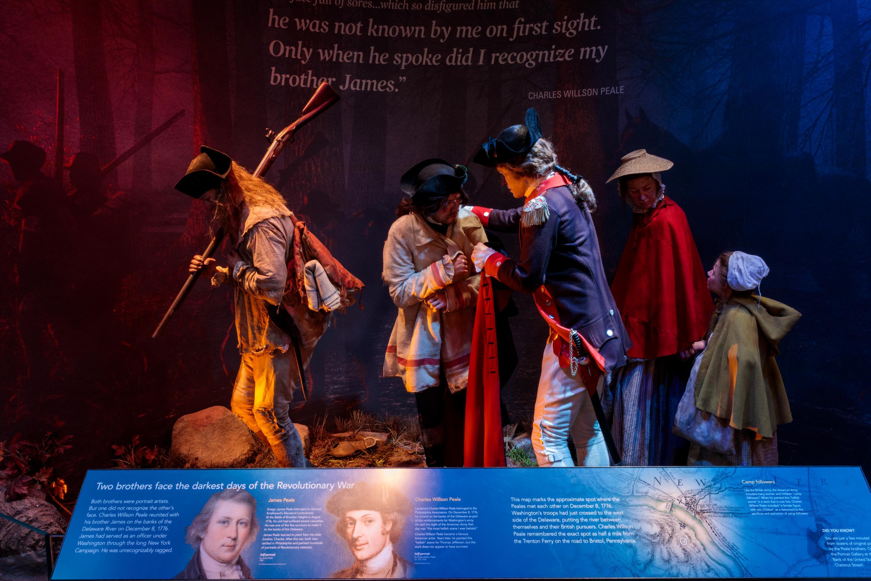 Lifelike figures of three men, a woman, and a child, behind a placard with text on it