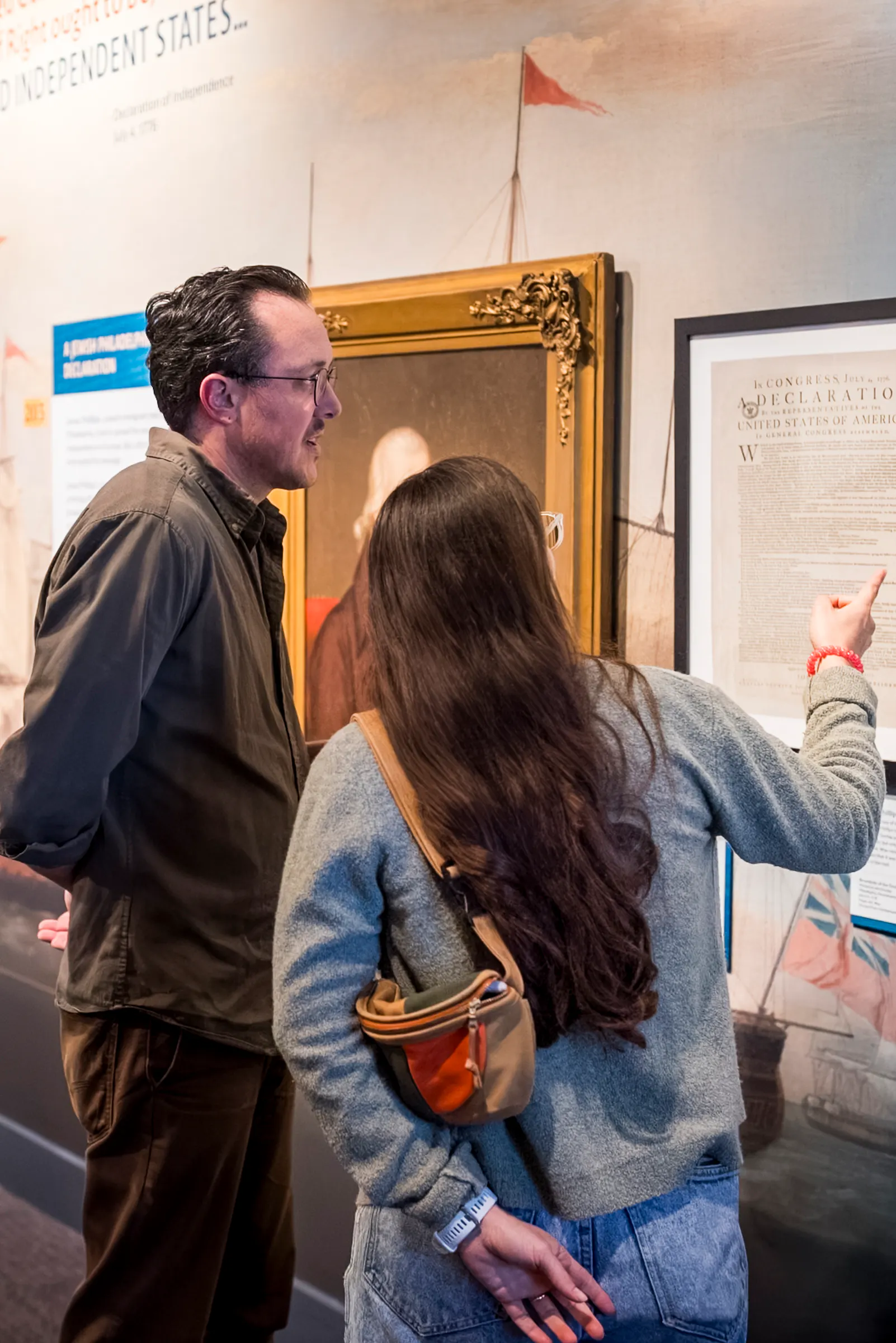 Two people look at a framed document in The Declaration's Journey