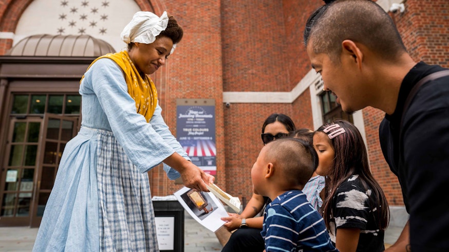 Kalela Williams interacts with young guests at a Discovery Cart on the Museum's Plaza as part of our Meet the Revolution series.