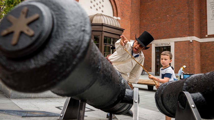 Noah Lewis portrays Ned Hector and teaches a young guest how to fire a cannon as part of our Meet The Revolution series.