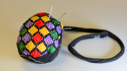 Replica Pinball or round pincushion sewn at an Artisan Workshop.