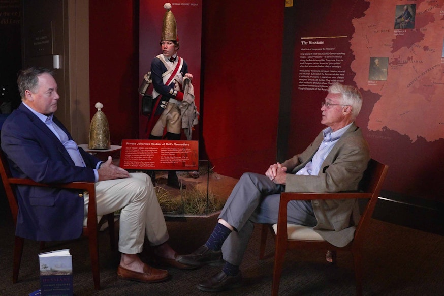 Dr. R. Scott Stephenson sits on the left facing archaeologist Wade Catts in the Museum galleries.