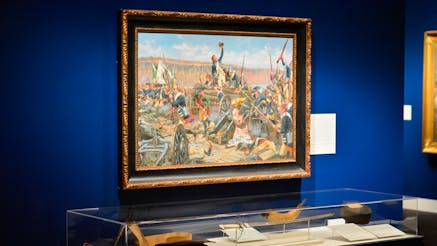A painting by Don Troiani on view alongside objects depicted in the painting in the Museum's Liberty Exhibit