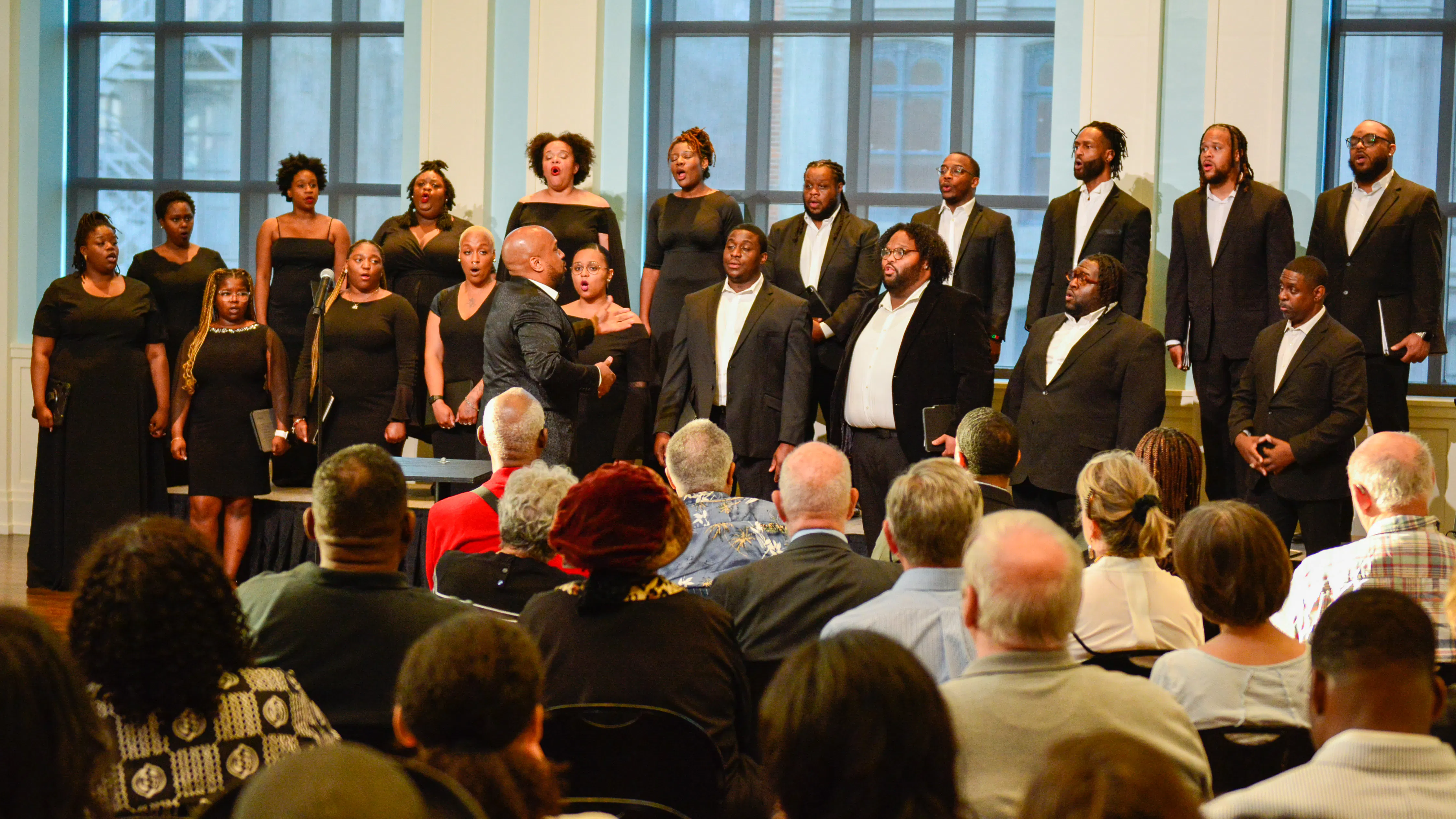 A group of singers performs in front of a crowd