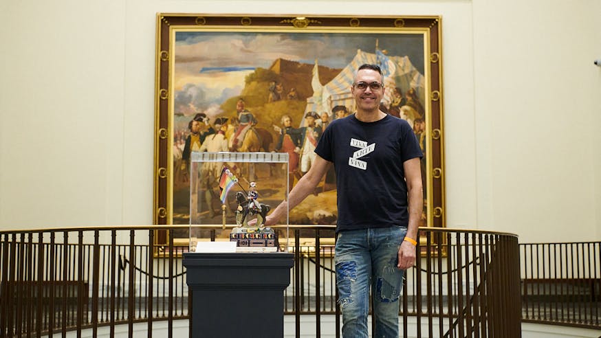 Artist John Wind stands next to his piece depicting Baron von Steuben in the Museum's second-floor Oneida Nation Atrium.