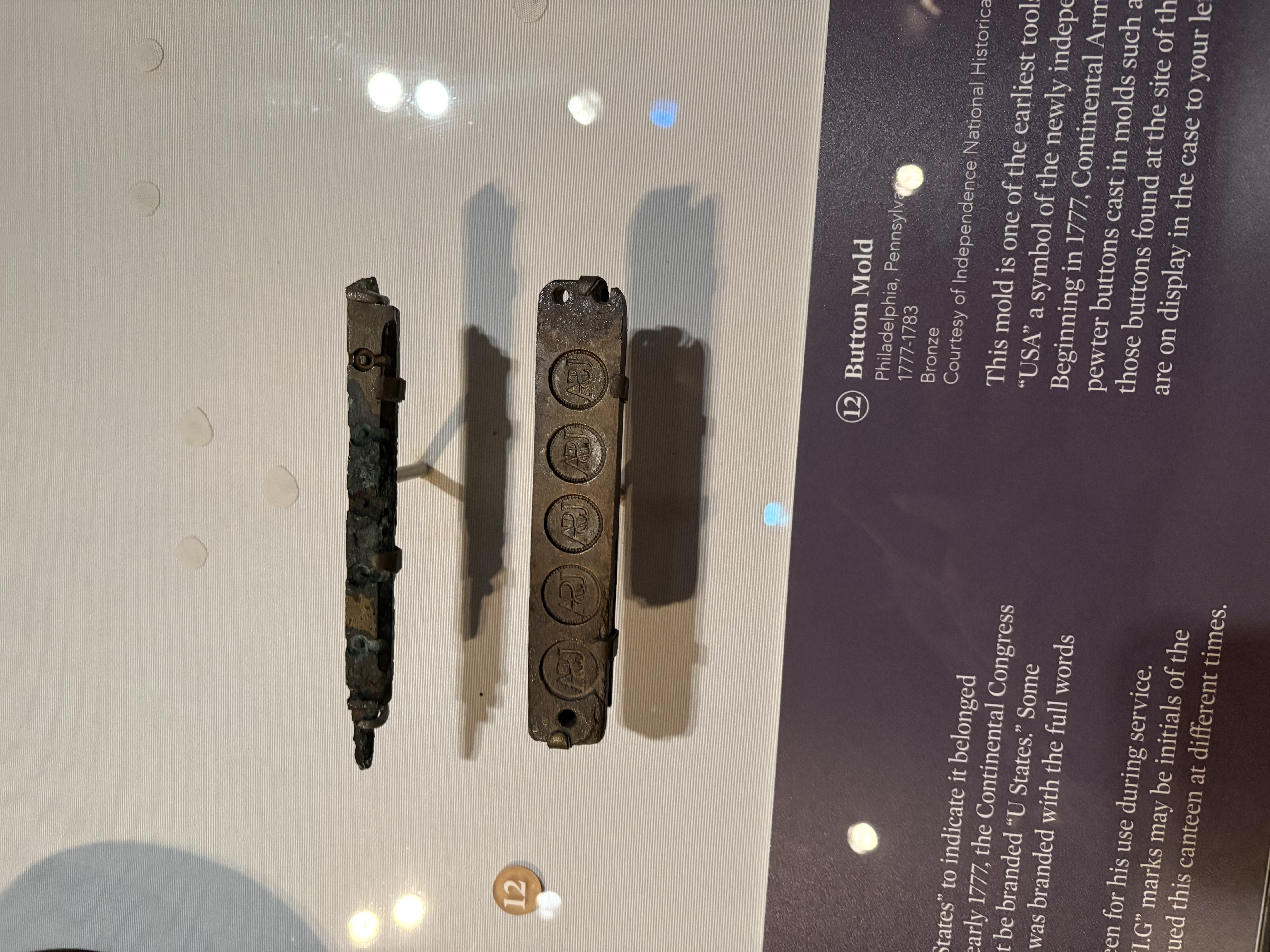 Small strips of metal mounted in a glass case