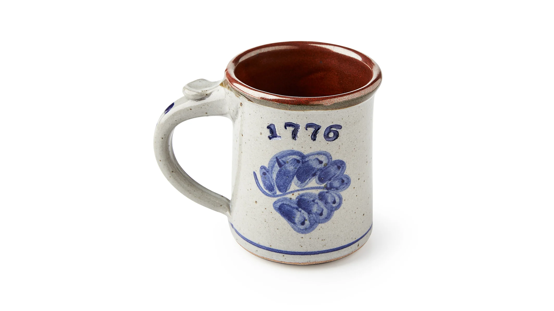 A pale gray mug with a blue leaf and 1776 painted on it