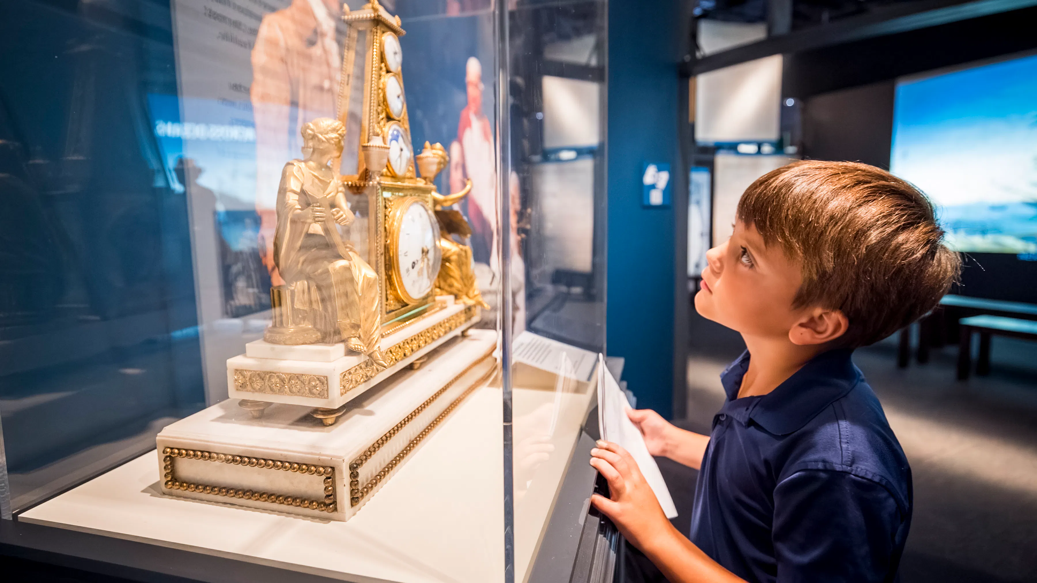 Kid viewing Clock of Louis XVI celebrating the American alliance, circa 1783 in American-French alliance section of The Declaration's Journey