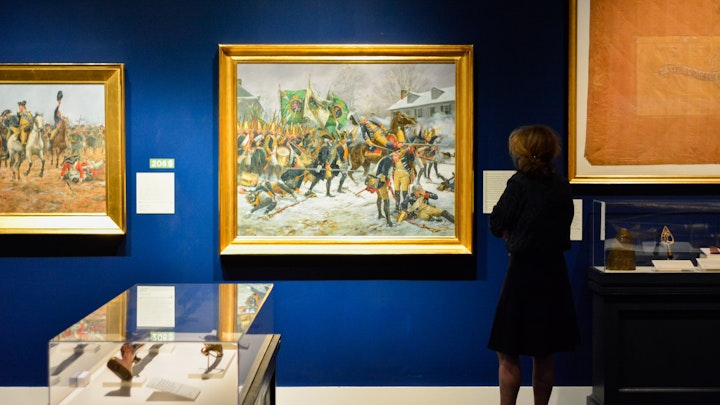 A Museum guest views a painting in the Liberty special exhibition.