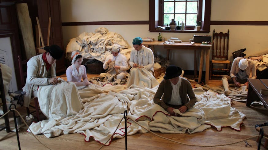Staff members from the Museum of the American Revolution and Colonial Williamsburg work on sewing the Museum's replica of George Washington's headquarters tent