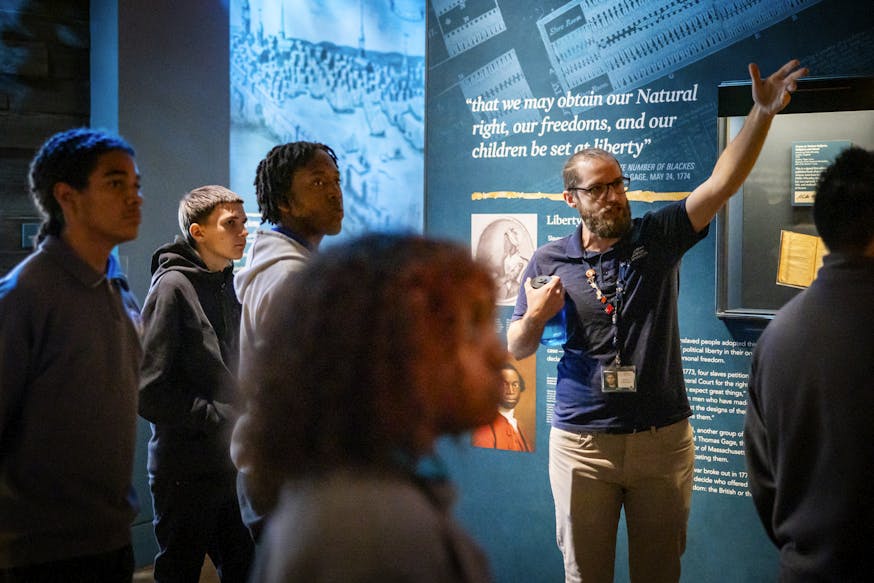 A Museum educator leads a school group tour through the Museum's core exhibition.