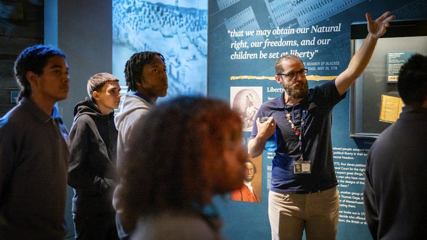 A Museum educator leads a school group tour through the Museum's core exhibition.