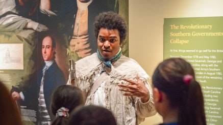 Joel Cook talks with students in the Museum for 2019 Meet The Revolution programming.