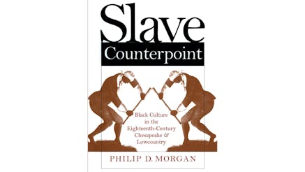 This image shows the book cover of Slave Counterpoint: Black Culture in the Eighteenth-Century Chesapeake and Lowcountry by Philip Morgan. The background is white. “Slave Counterpoint” is written in black at the top of the cover. The subtitle is written in a deep red towards the bottom of the cover. There is a mirror image of a slave, in a sepia tone, with a stick in their hand and with their heads pointing downward. The slave is standing on grass.