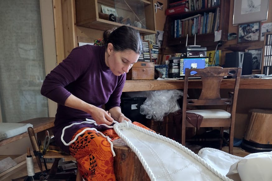 Force10 Sailmaking's Nahja Chimenti works on a sail in the family business's workshop.