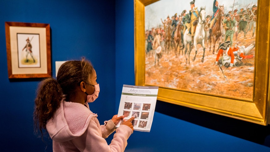 A young visitor finds a clue in the Liberty exhibit's family-friendly scavenger hunt.