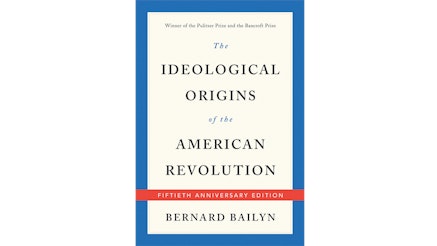 This image shows the book cover of The Ideological Origins of the American Revolution by Bernard Bailyn. It is a tan cover with a blue border. The title of the book and Bernard’s name are writing in black font.