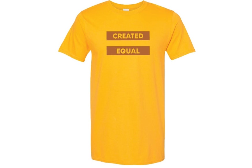 Yellow t-shirt with the words Created Equal across the checst.