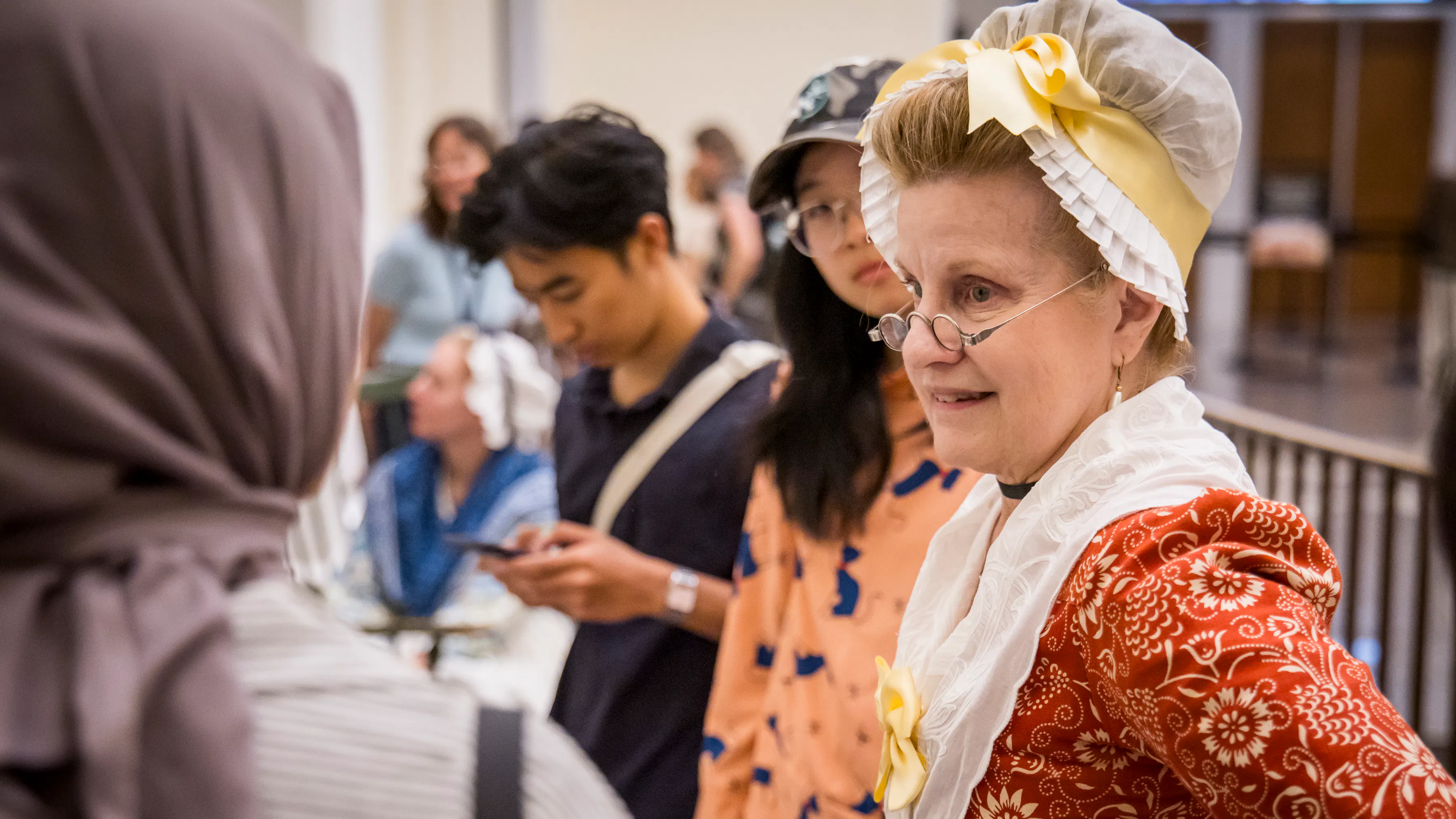 A costumed interpreter talks with guests