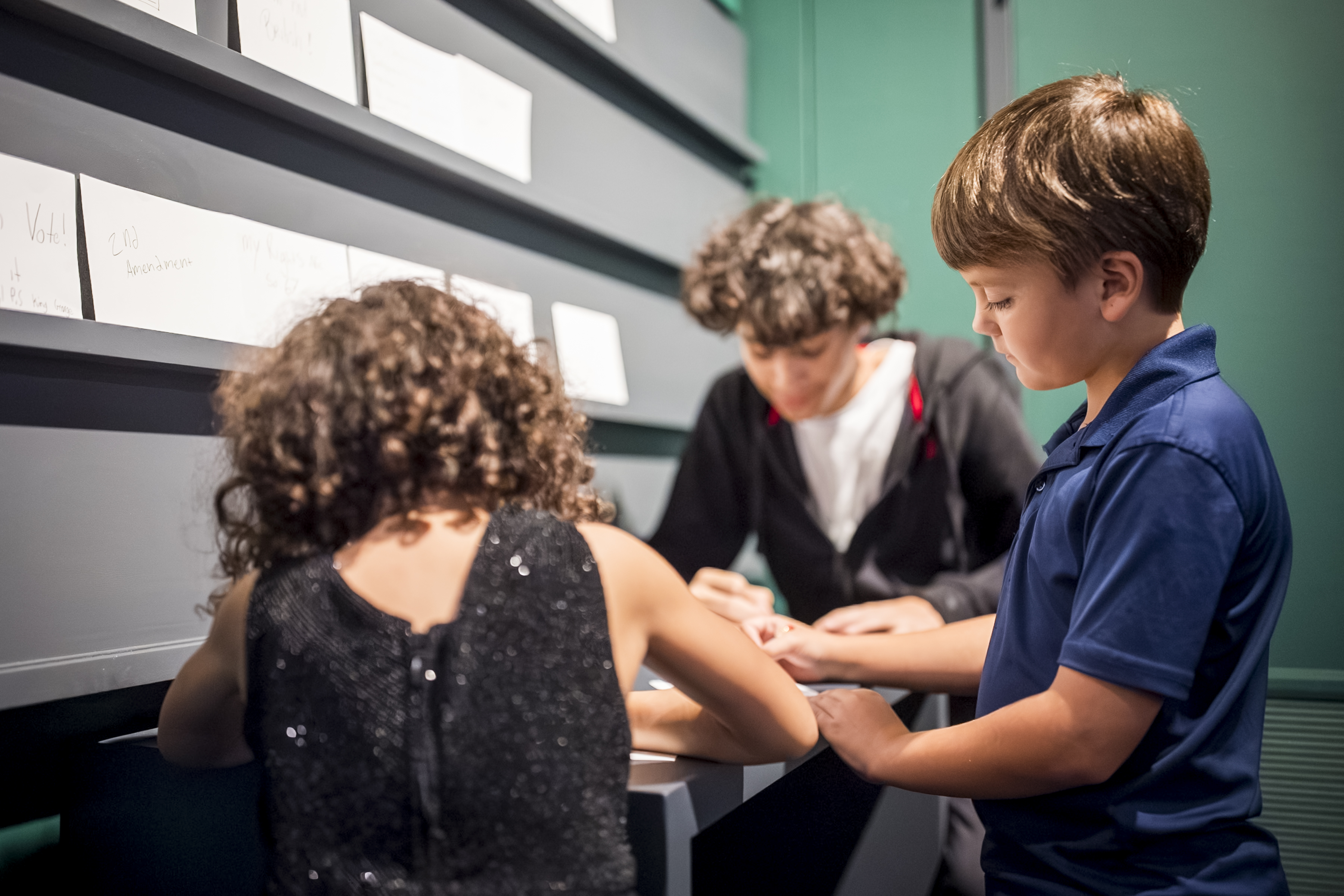 Children interact with the talk-back wall in "The Declaration's Journey"