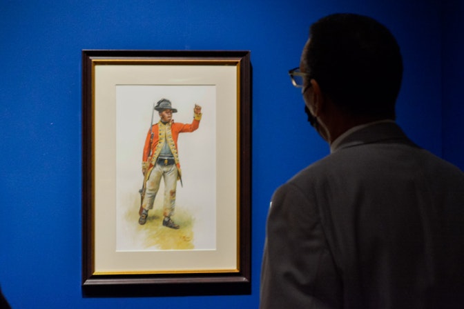 Ethopian Regiment Character Study shows a young black male soldier wearing a red coat and holding a musket.